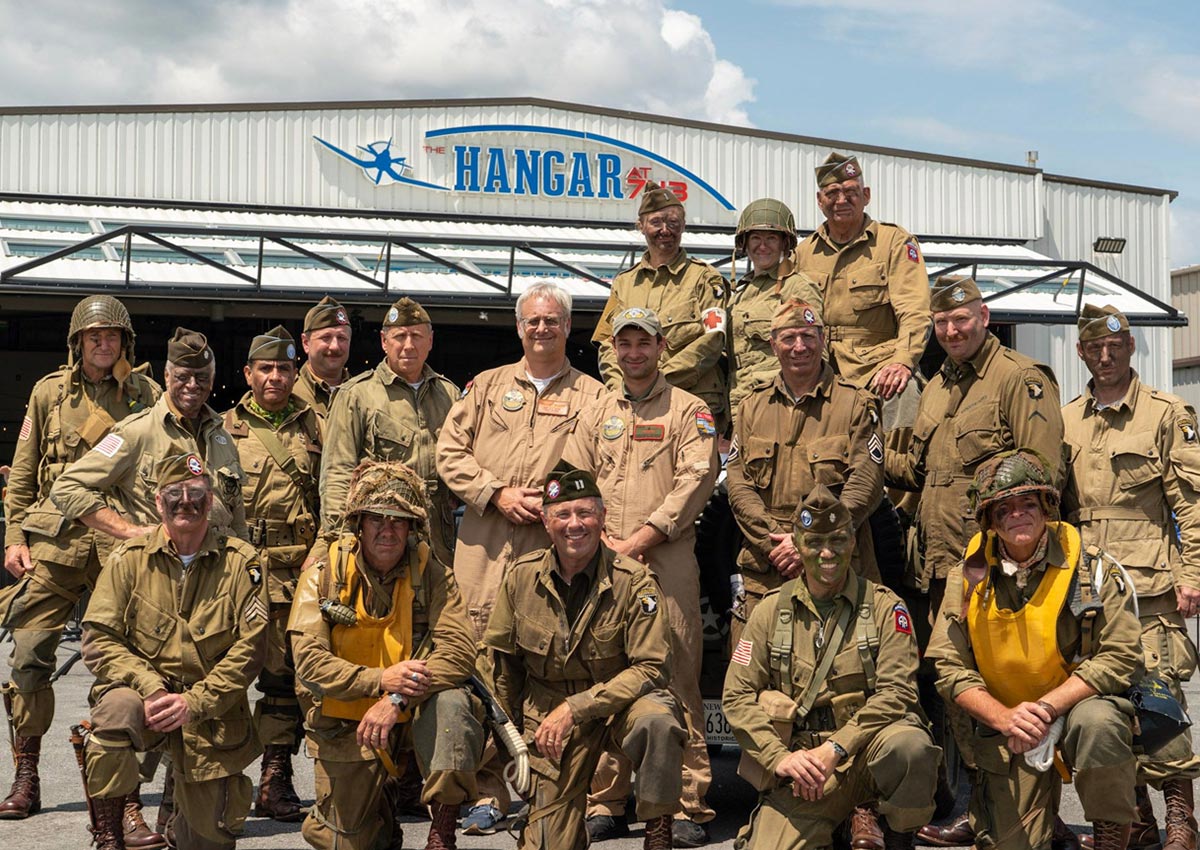 group picture in front of hangar