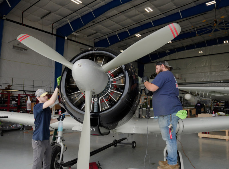 two technicians working on warbird at Warbird Factory